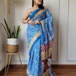 Blue Cotton MulMul Jaipuri Printed Saree with elegant traditional prints, lightweight breathable fabric, and matching blouse piece for a graceful ethnic look.