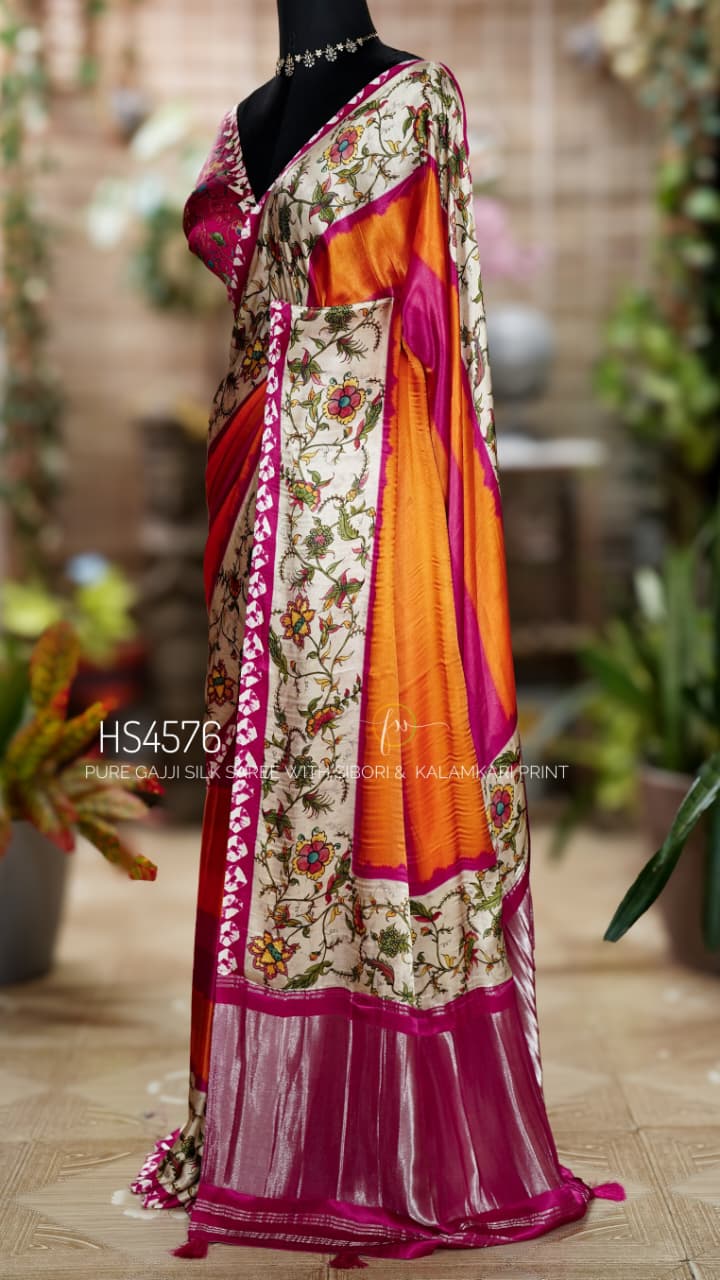 Pure Gajji Silk Saree with Kalamkari floral print, vibrant orange and rani pink Sibori design, Khaddi zari pallu, and elegant traditional festive wear look.