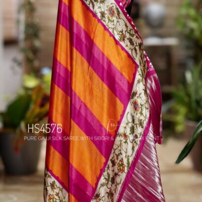 Pure Gajji Silk Saree with Kalamkari floral print, vibrant orange and rani pink Sibori design, Khaddi zari pallu, and elegant traditional festive wear look.