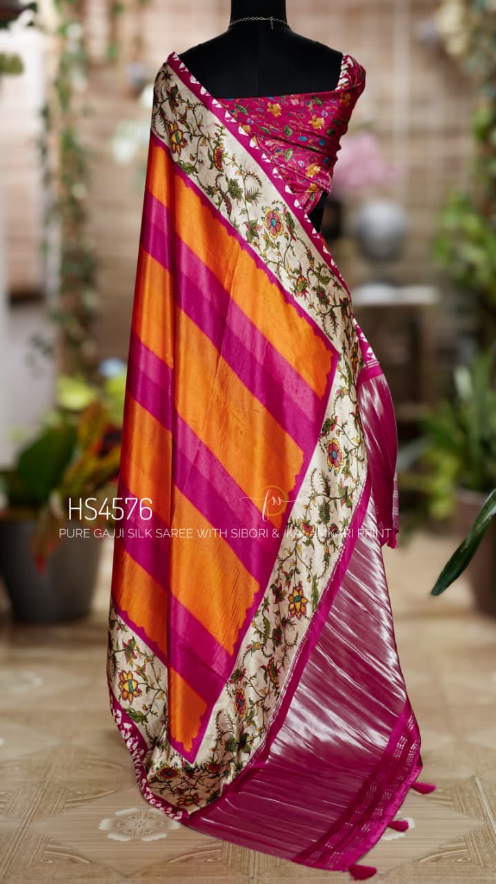 Pure Gajji Silk Saree with Kalamkari floral print, vibrant orange and rani pink Sibori design, Khaddi zari pallu, and elegant traditional festive wear look.