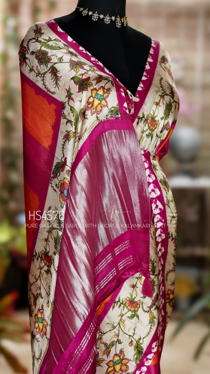 Pure Gajji Silk Saree with Kalamkari floral print, vibrant orange and rani pink Sibori design, Khaddi zari pallu, and elegant traditional festive wear look.