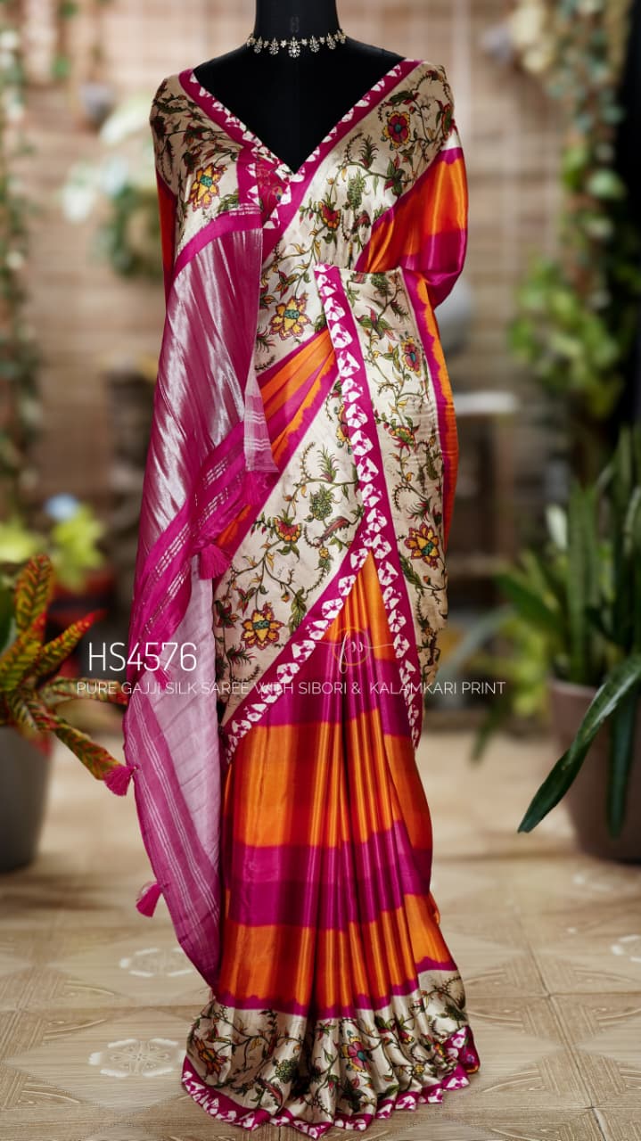 Pure Gajji Silk Saree with Kalamkari floral print, vibrant orange and rani pink Sibori design, Khaddi zari pallu, and elegant traditional festive wear look.