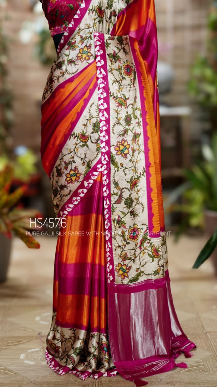 Pure Gajji Silk Saree for women featuring Kalamkari print, Sibori pattern, orange pink color combination, Khaddi zari pallu, and matching printed blouse. Pure Gajji Silk Saree with Kalamkari floral print, vibrant orange and rani pink Sibori design, Khaddi zari pallu, and elegant traditional festive wear look.