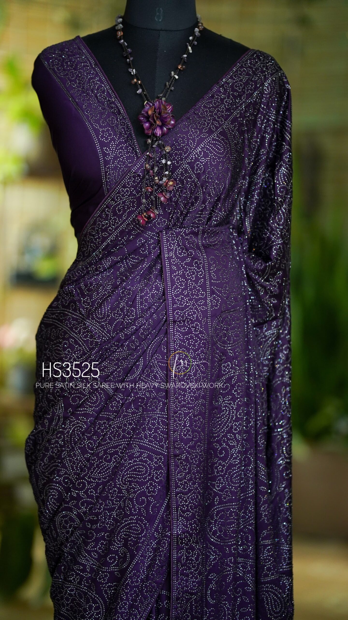 Purple Satin Silk Saree with Swarovski Work featuring a luxurious glossy finish, elegant drape, sparkling embellishments, and matching bordered blouse for partywear and wedding occasions.