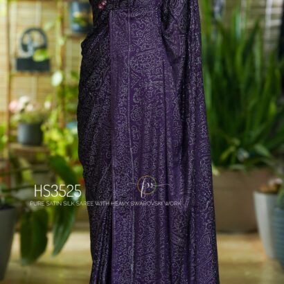 Purple Satin Silk Saree with Swarovski Work featuring a luxurious glossy finish, elegant drape, sparkling embellishments, and matching bordered blouse for partywear and wedding occasions.