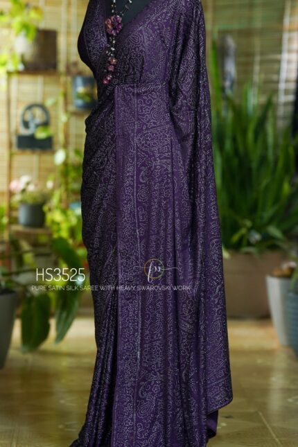 Purple Satin Silk Saree with Swarovski Work featuring a luxurious glossy finish, elegant drape, sparkling embellishments, and matching bordered blouse for partywear and wedding occasions.