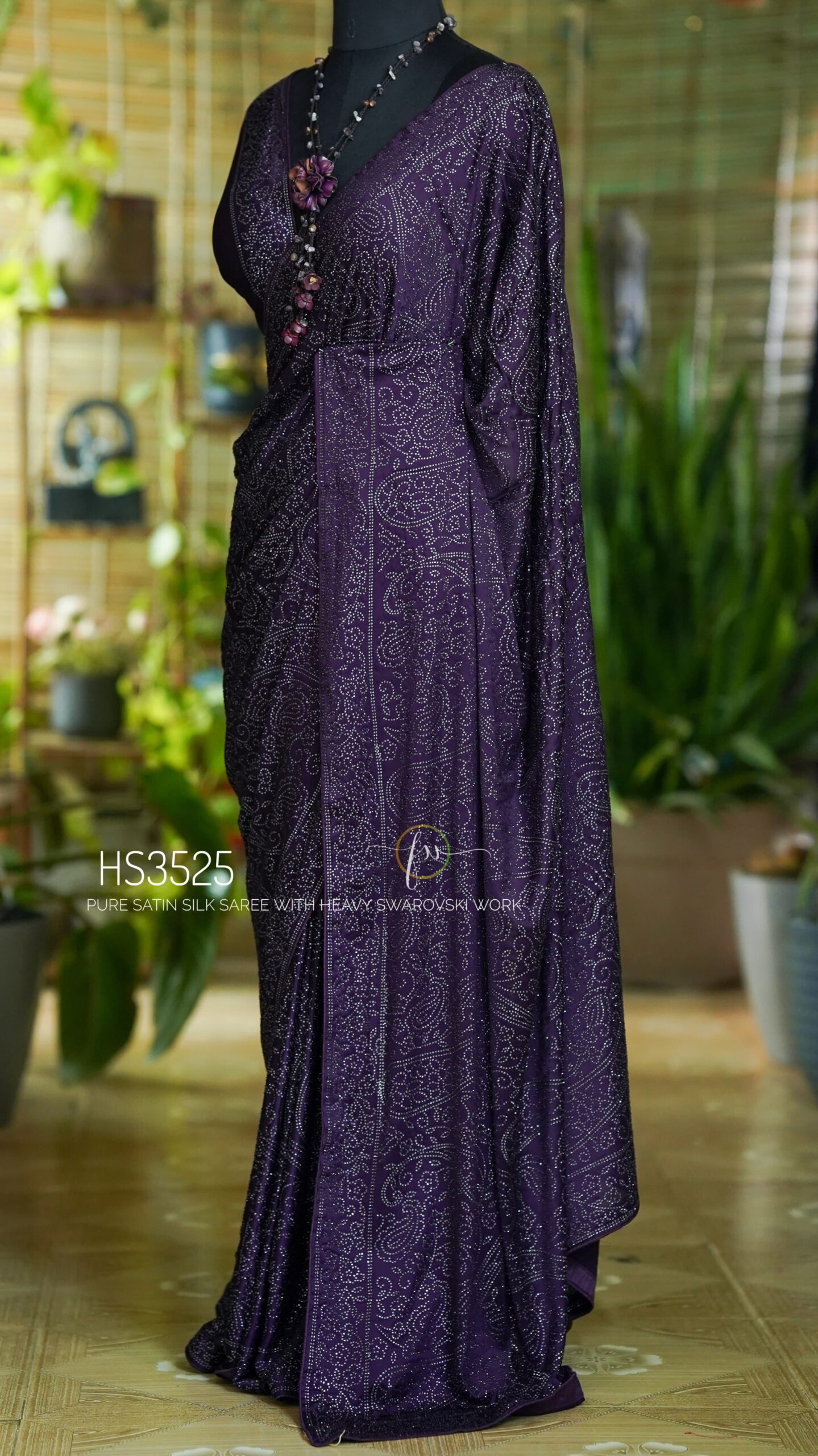 Purple Satin Silk Saree with Swarovski Work featuring a luxurious glossy finish, elegant drape, sparkling embellishments, and matching bordered blouse for partywear and wedding occasions.