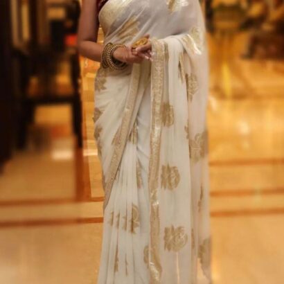 Viscose Georgette Saree with Contrast Blouse in White Gold shade featuring floral zari motifs and elegant woven border.
