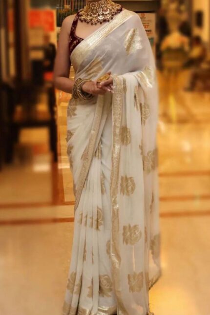 Viscose Georgette Saree with Contrast Blouse in White Gold shade featuring floral zari motifs and elegant woven border.