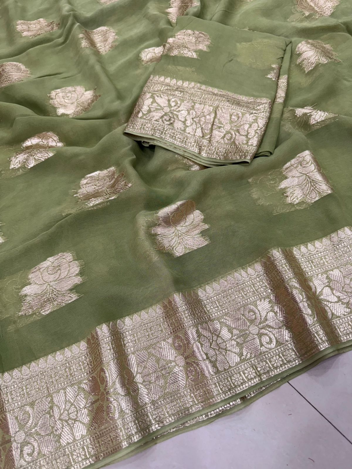 Viscose Georgette Saree with Contrast Blouse in Sage Green Gold shade featuring floral zari motifs and elegant woven border.