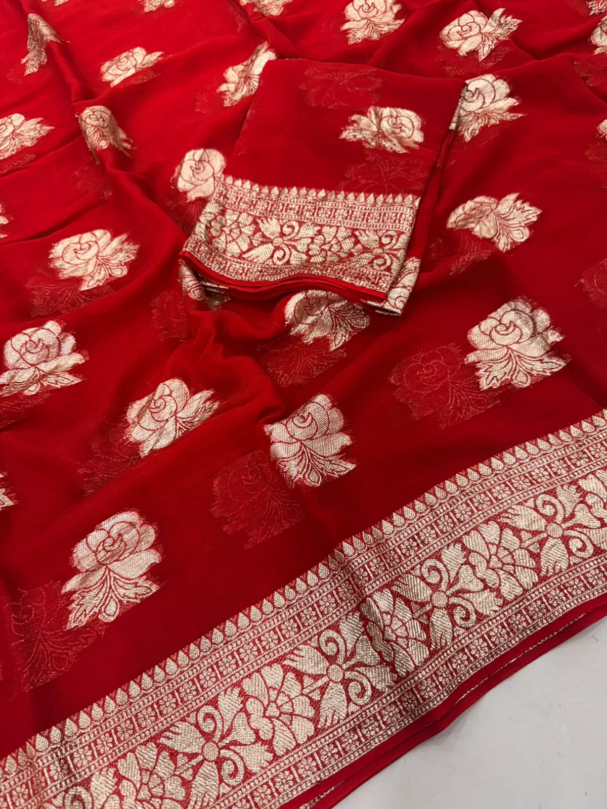 Viscose Georgette Saree with Contrast Blouse in Red Gold shade featuring floral zari motifs and elegant woven border.