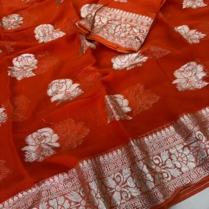 Viscose Georgette Saree with Contrast Blouse in Rust Orange Gold shade featuring floral zari motifs and elegant woven border.