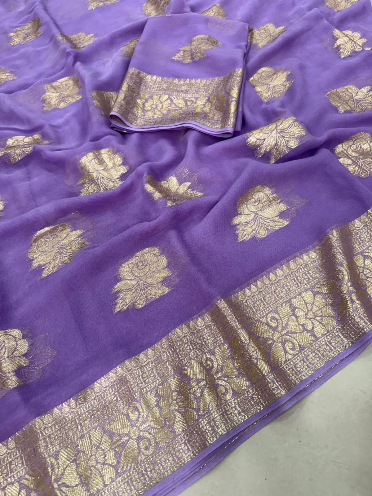 Viscose Georgette Saree with Contrast Blouse in Lavender Purple Gold shade featuring floral zari motifs and elegant woven border.
