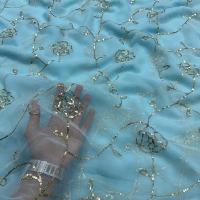 Royal Georgette Aari Work Saree in Sky Blue Color featuring intricate Aari Tari embroidery, elegant drape, premium georgette fabric, and graceful ethnic party wear look.