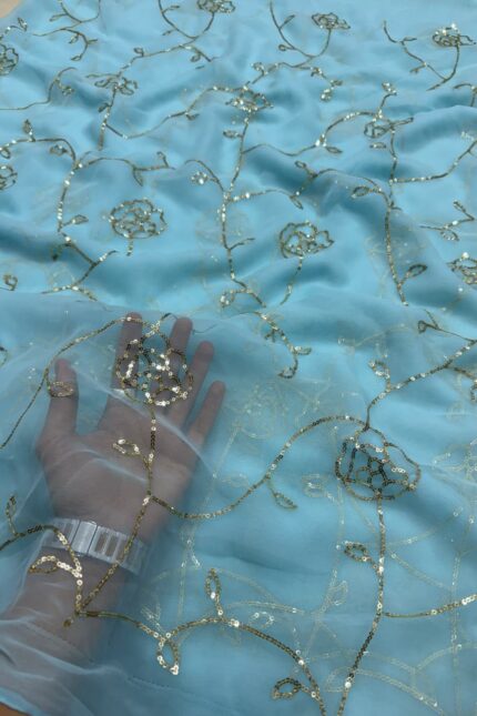Royal Georgette Aari Work Saree in Sky Blue Color featuring intricate Aari Tari embroidery, elegant drape, premium georgette fabric, and graceful ethnic party wear look.