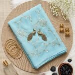 Royal Georgette Aari Work Saree in Sky Blue Color featuring intricate Aari Tari embroidery, elegant drape, premium georgette fabric, and graceful ethnic party wear look.