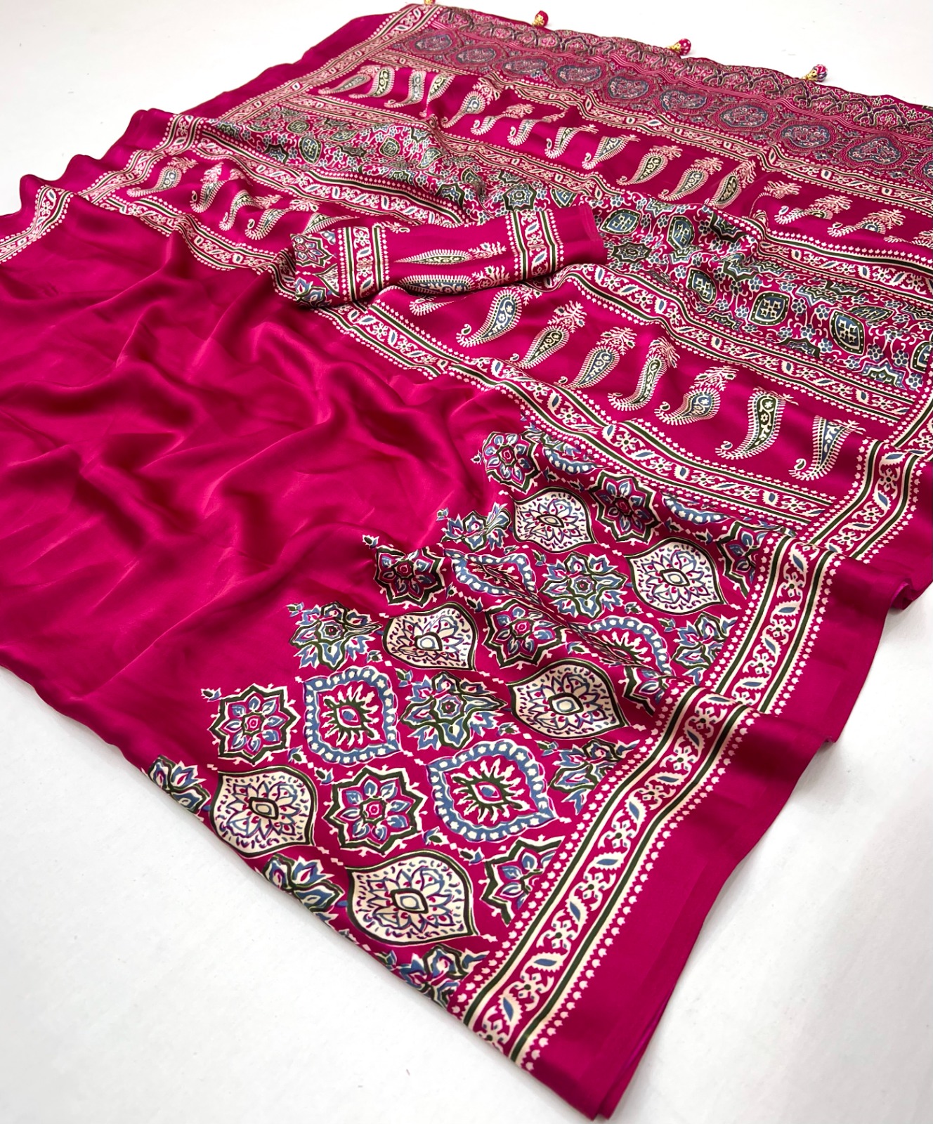 Ajrakh Satin Silk Saree in premium Modal Satin Silk with elegant digital print, tassels on pallu, 6.3 meter saree with matching blouse piece for festive and party wear.