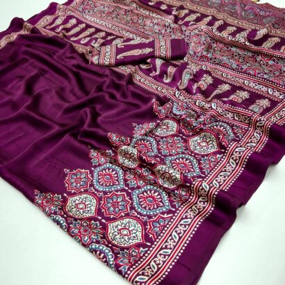 Ajrakh Satin Silk Saree in premium Modal Satin Silk with elegant digital print, tassels on pallu, 6.3 meter saree with matching blouse piece for festive and party wear.