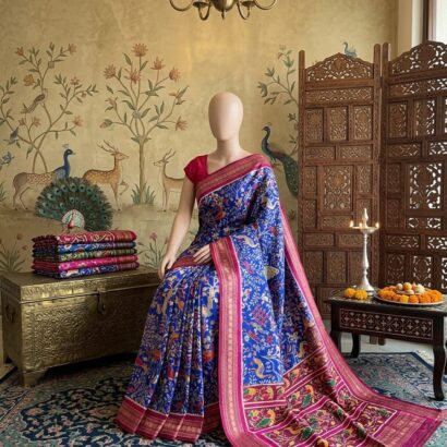 Blue Patola Silk Saree with Shikargah Print featuring intricate deer, elephant and bird motifs, rich sapphire blue double ikat design, magenta border, and gold zari pallu for festive and wedding wear.