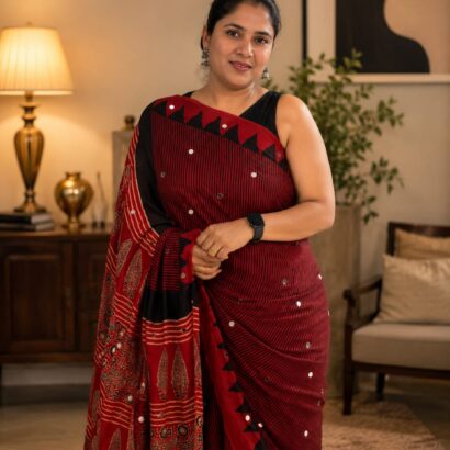 Pure Modal Silk Saree in Maroon Red with natural dye hand block print, 500 hand-pasted mirror work, striped design and designer pallu for festive, wedding and party wear.