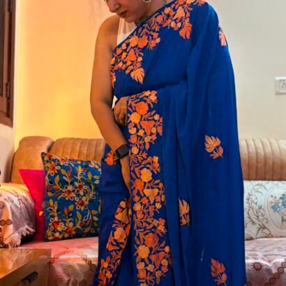 Blue Kashmiri silk saree with intricate handcrafted Aari Resham border embroidery and matching blouse piece.