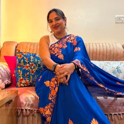 Blue Kashmiri silk saree with intricate handcrafted Aari Resham border embroidery and matching blouse piece.