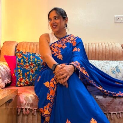 Blue Kashmiri silk saree with intricate handcrafted Aari Resham border embroidery and matching blouse piece.