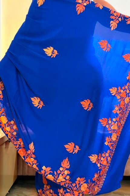 Blue Kashmiri silk saree with intricate handcrafted Aari Resham border embroidery and matching blouse piece.
