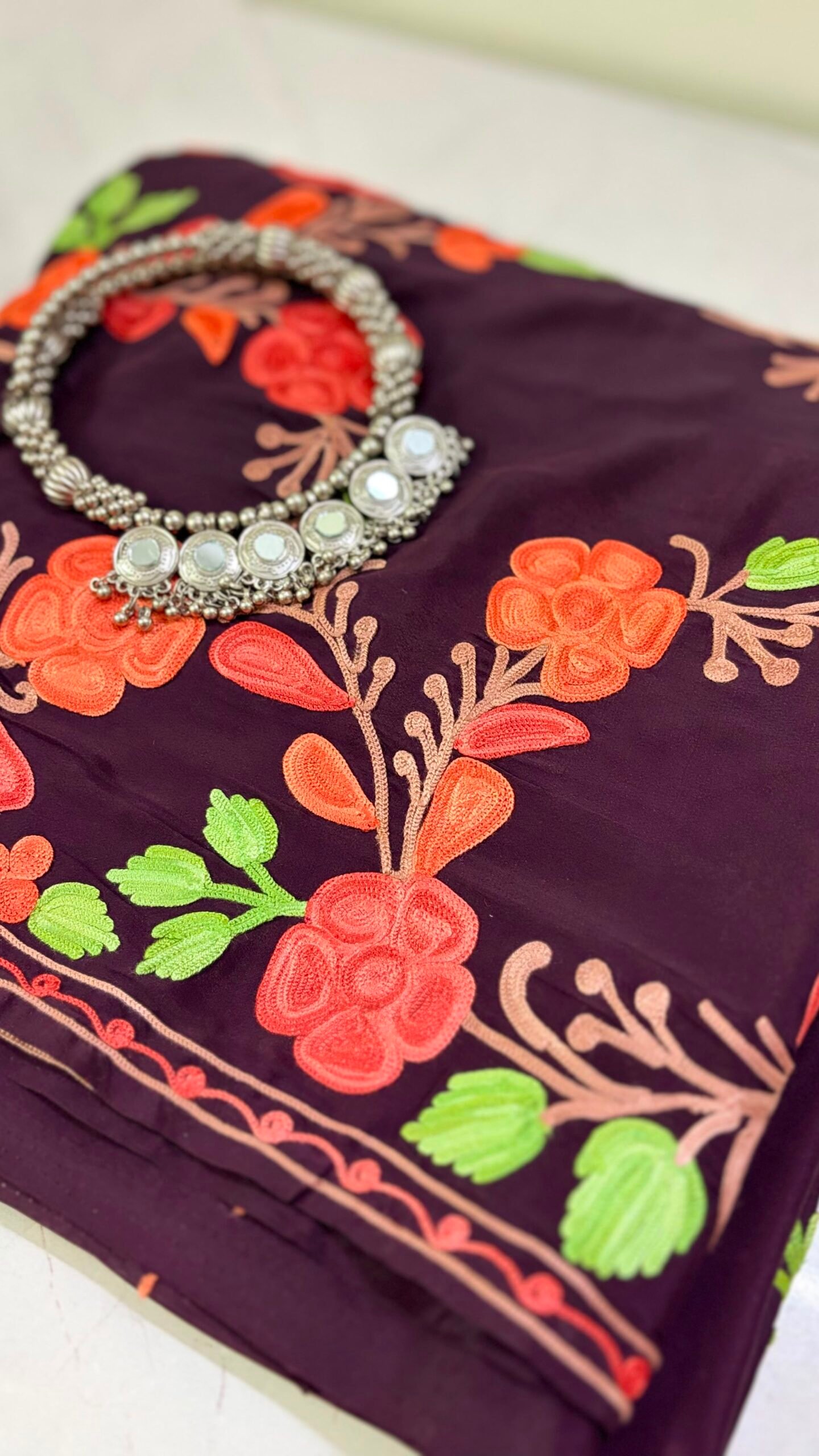 Wine purple Kashmiri pure crepe silk saree featuring authentic Aari Resham border embroidery and running blouse piece.