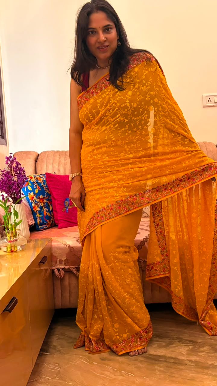Yellow pure georgette saree with intricate Kashmiri border and Chikankari embroidery body