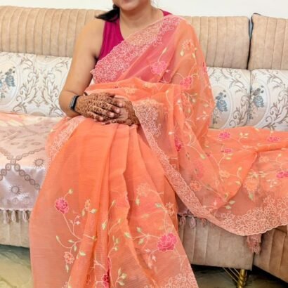Peach Kota Doria saree with floral Parsi embroidery