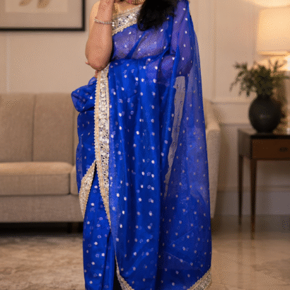 Royal blue Banarasi silk saree featuring gold zari floral booti weaving and Sabyasachi-style mirror work lace border