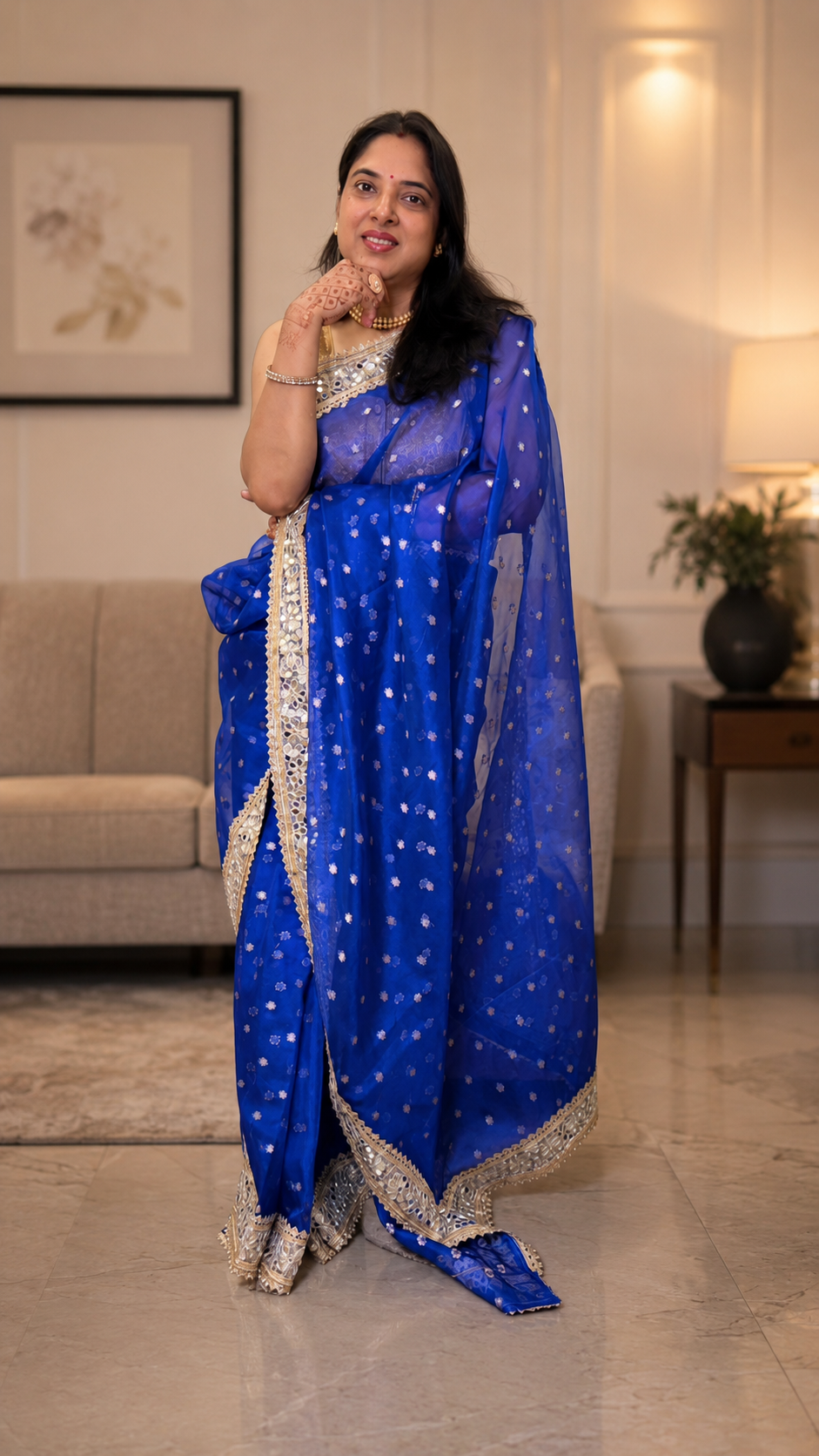 Royal blue Banarasi silk saree featuring gold zari floral booti weaving and Sabyasachi-style mirror work lace border
