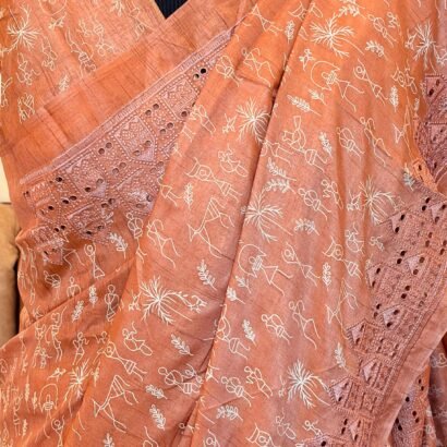 Peach color Pure tussar silk saree with cutwork borders and warli print, paired with a printed blouse