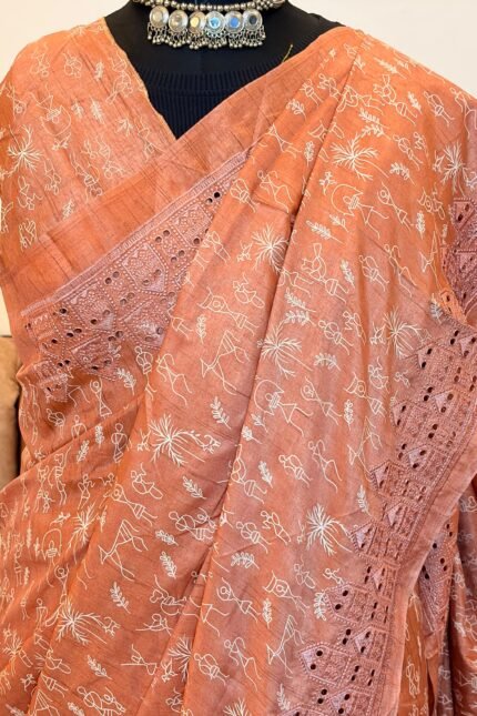 Peach color Pure tussar silk saree with cutwork borders and warli print, paired with a printed blouse