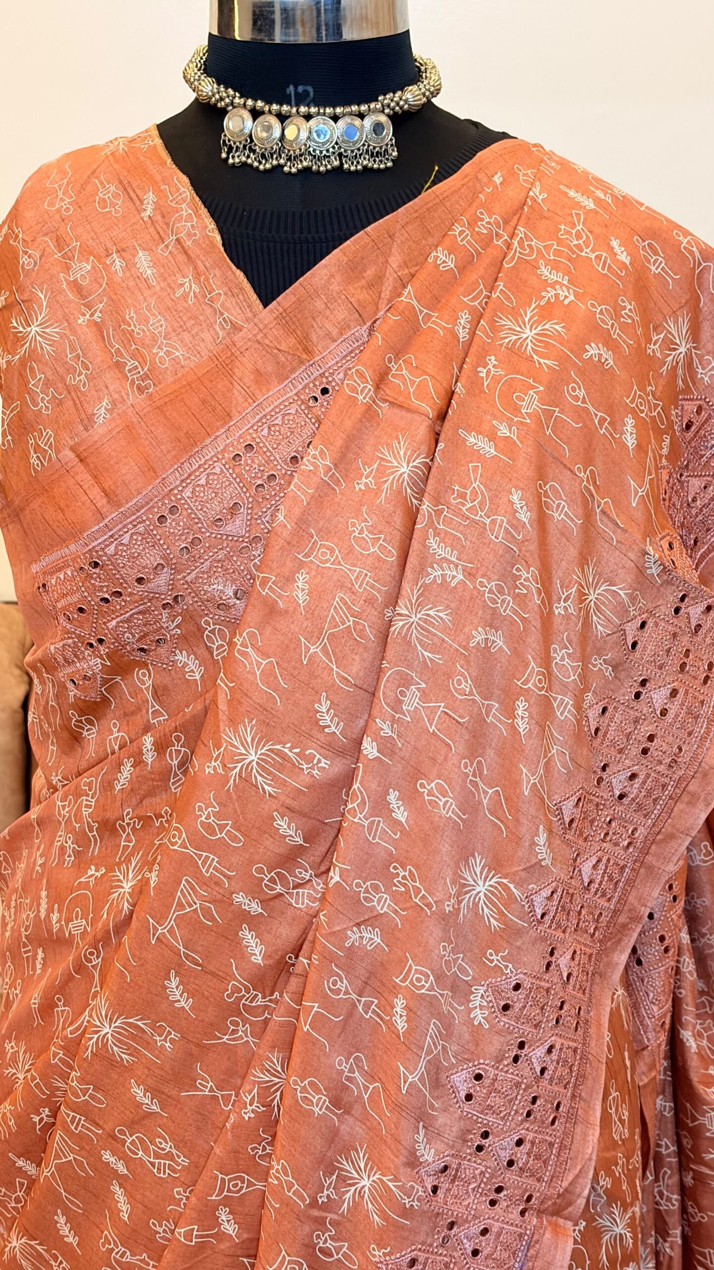 Peach color Pure tussar silk saree with cutwork borders and warli print, paired with a printed blouse