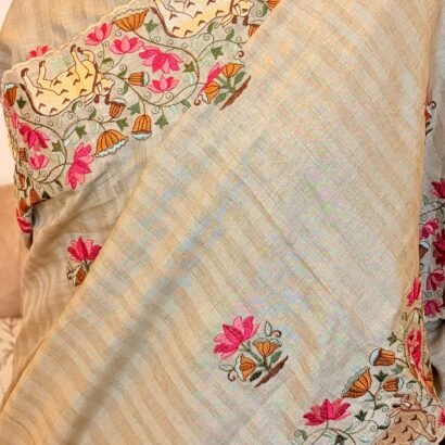 Elegant tussar silk saree with paichwai embroidery, scalloped border and lotus-cow motifs