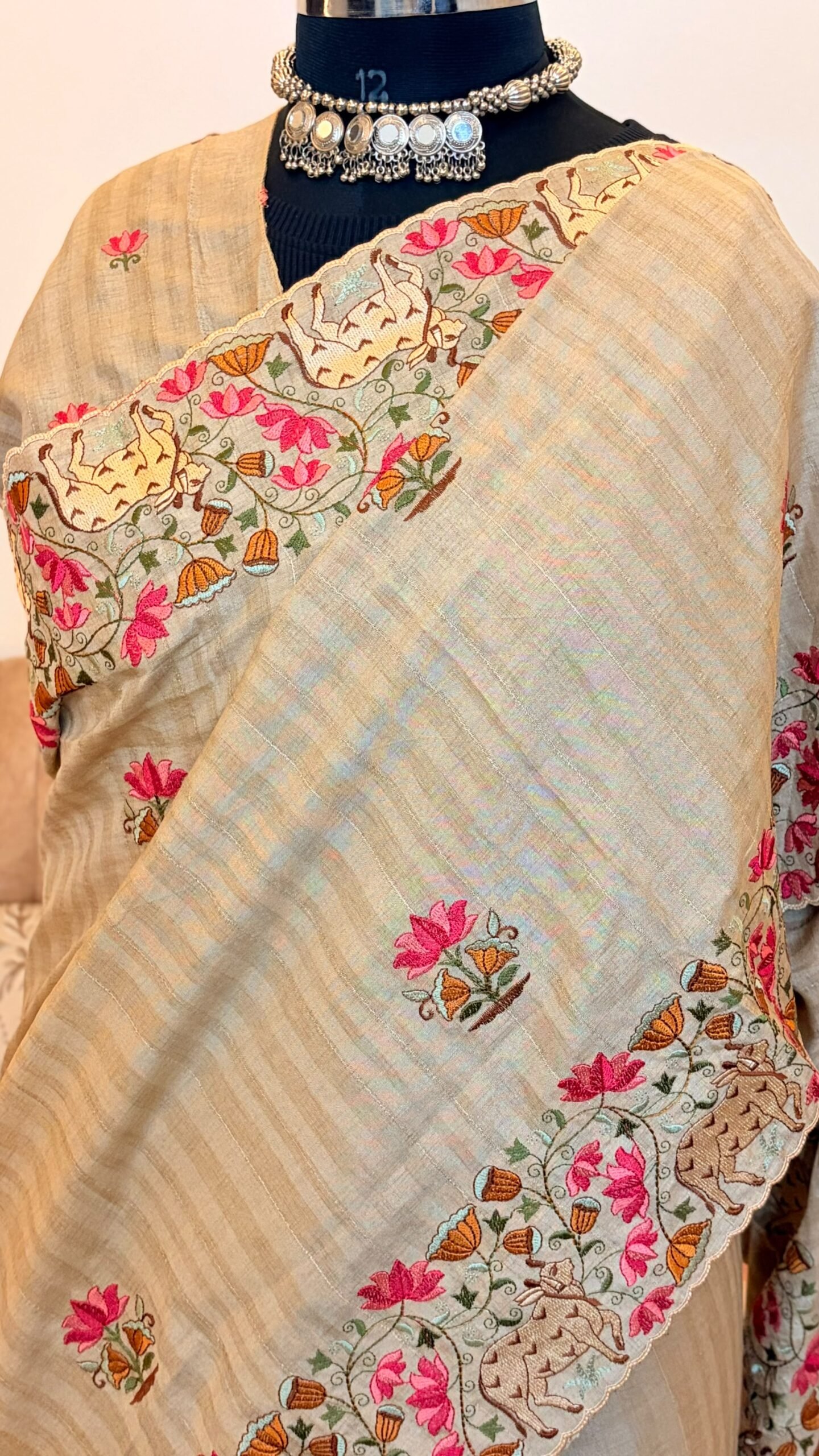 Elegant tussar silk saree with paichwai embroidery, scalloped border and lotus-cow motifs