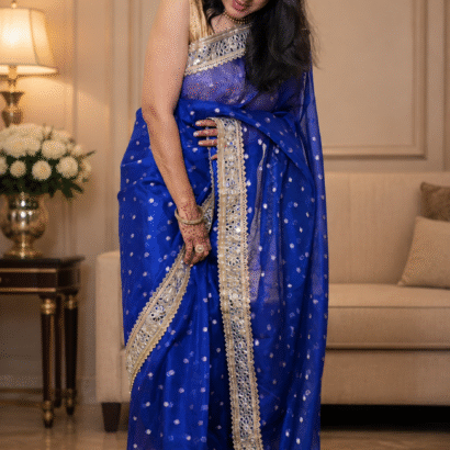 Royal blue Banarasi silk saree featuring gold zari floral booti weaving and Sabyasachi-style mirror work lace border