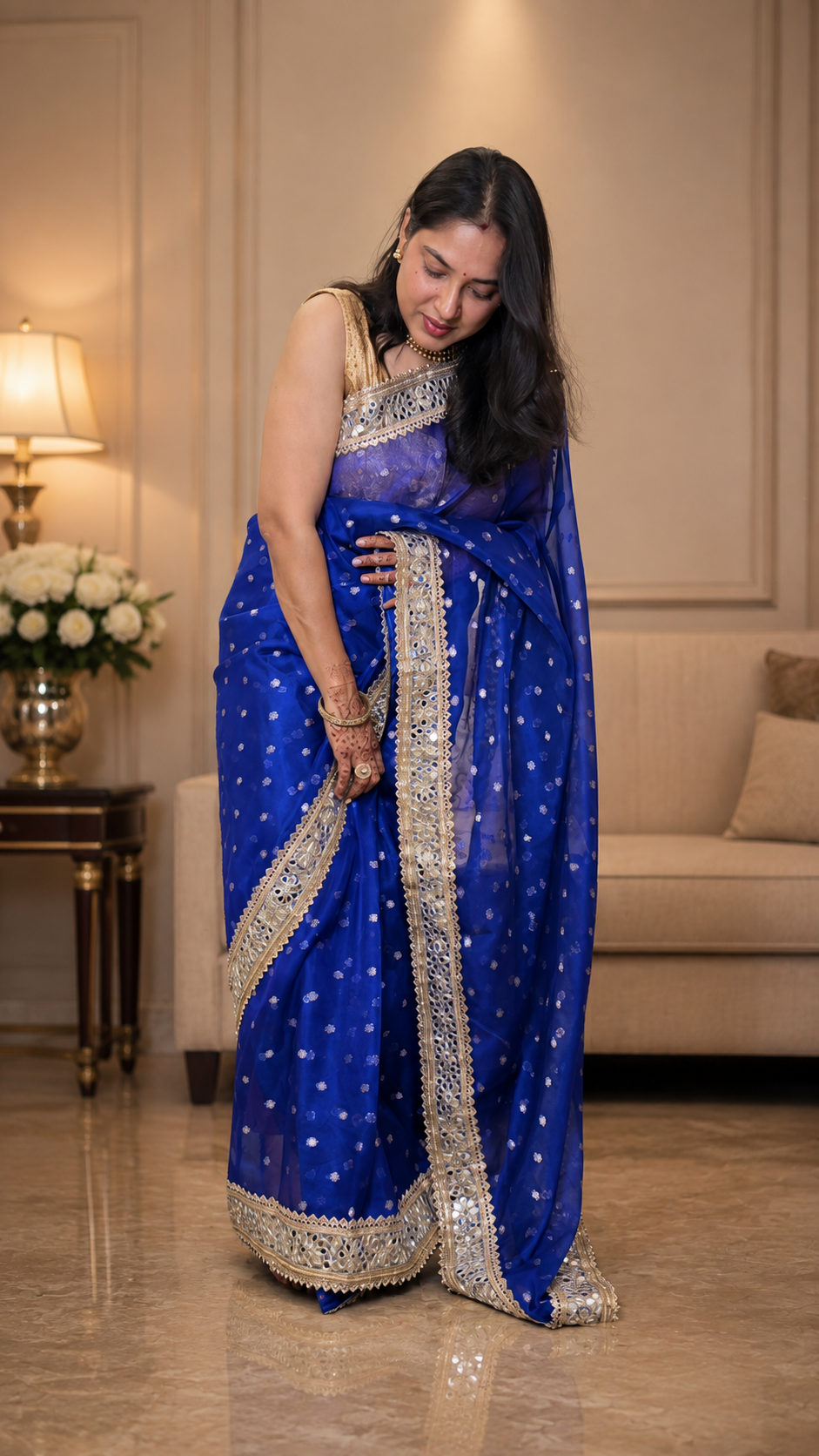 Royal blue Banarasi silk saree featuring gold zari floral booti weaving and Sabyasachi-style mirror work lace border